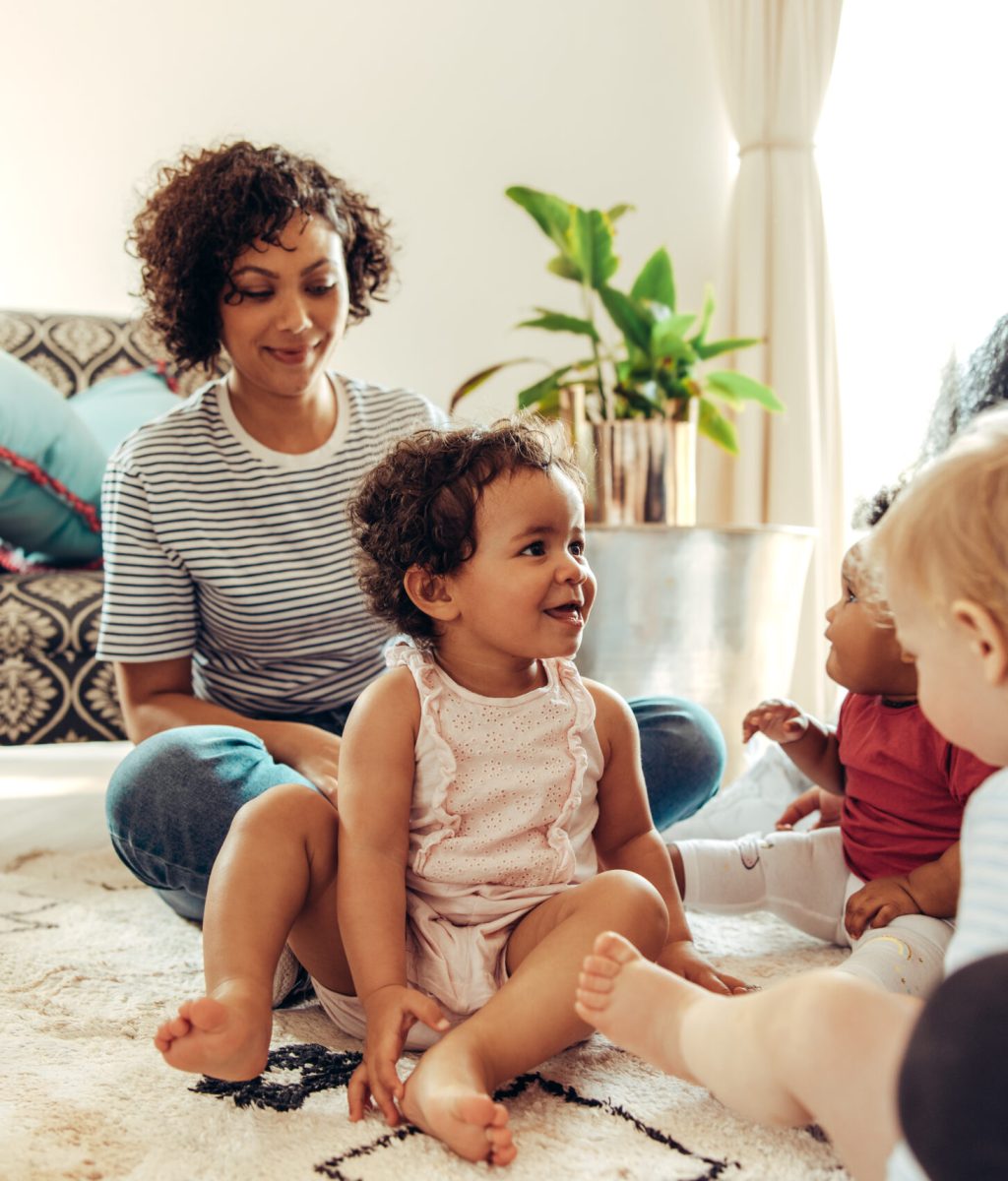 Mothers,In,The,Living,Room,Looking,At,Their,Babies,Playing.